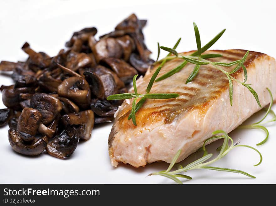 Grilled fish, salmon steak with mushrooms