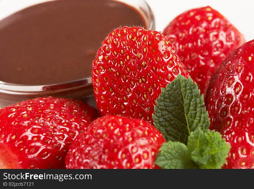 A plate of strawberries and chocolate sauce