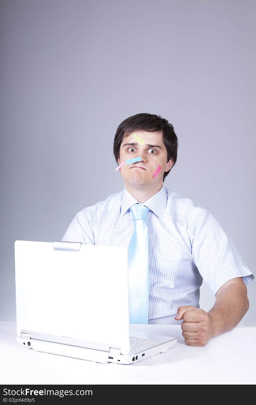 Young boss with white laptop and notes. Young boss with white laptop and notes.