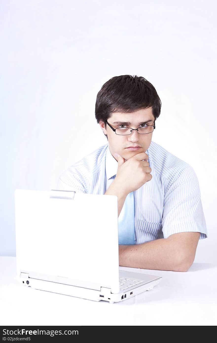 Young boss with white laptop. Studio shot.