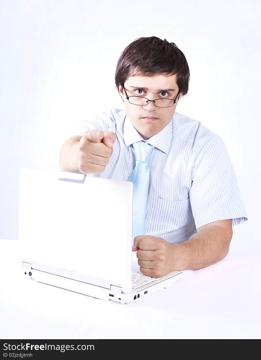 Young boss with white laptop. Studio shot.