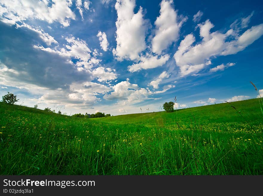 Blue sky with clouds and field