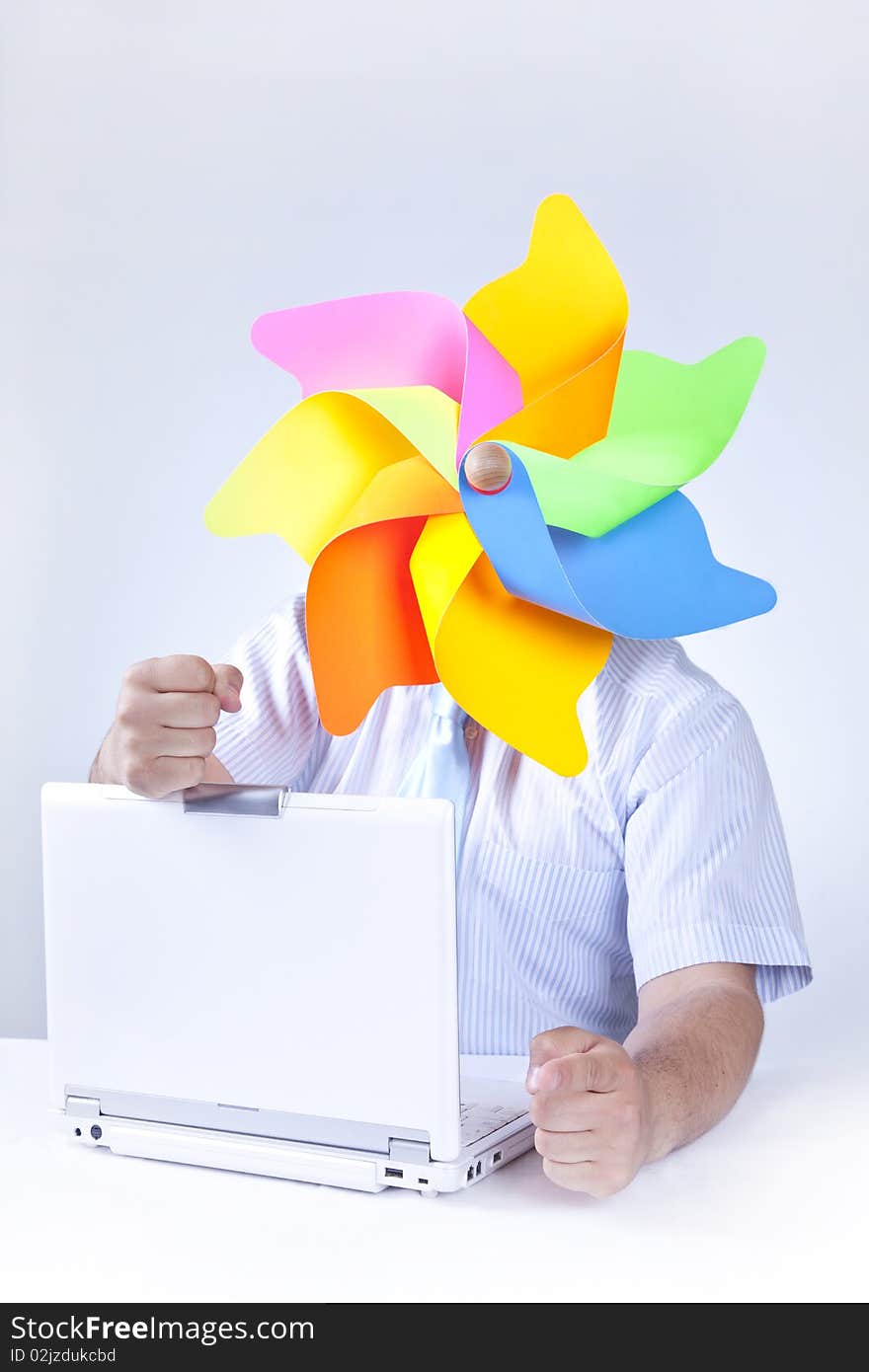 Businessman with wind turbine at head with notebook.