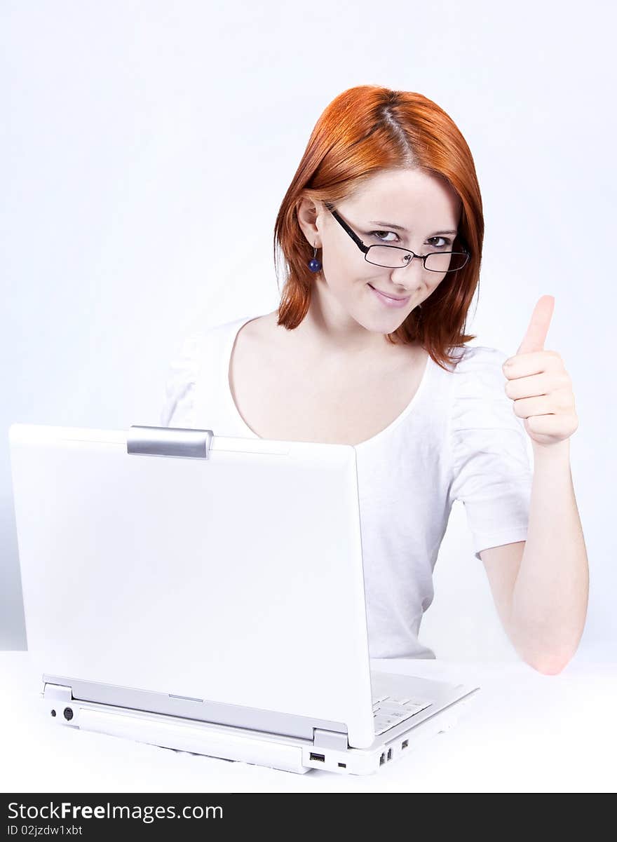 Red-haired girl with white notebook.