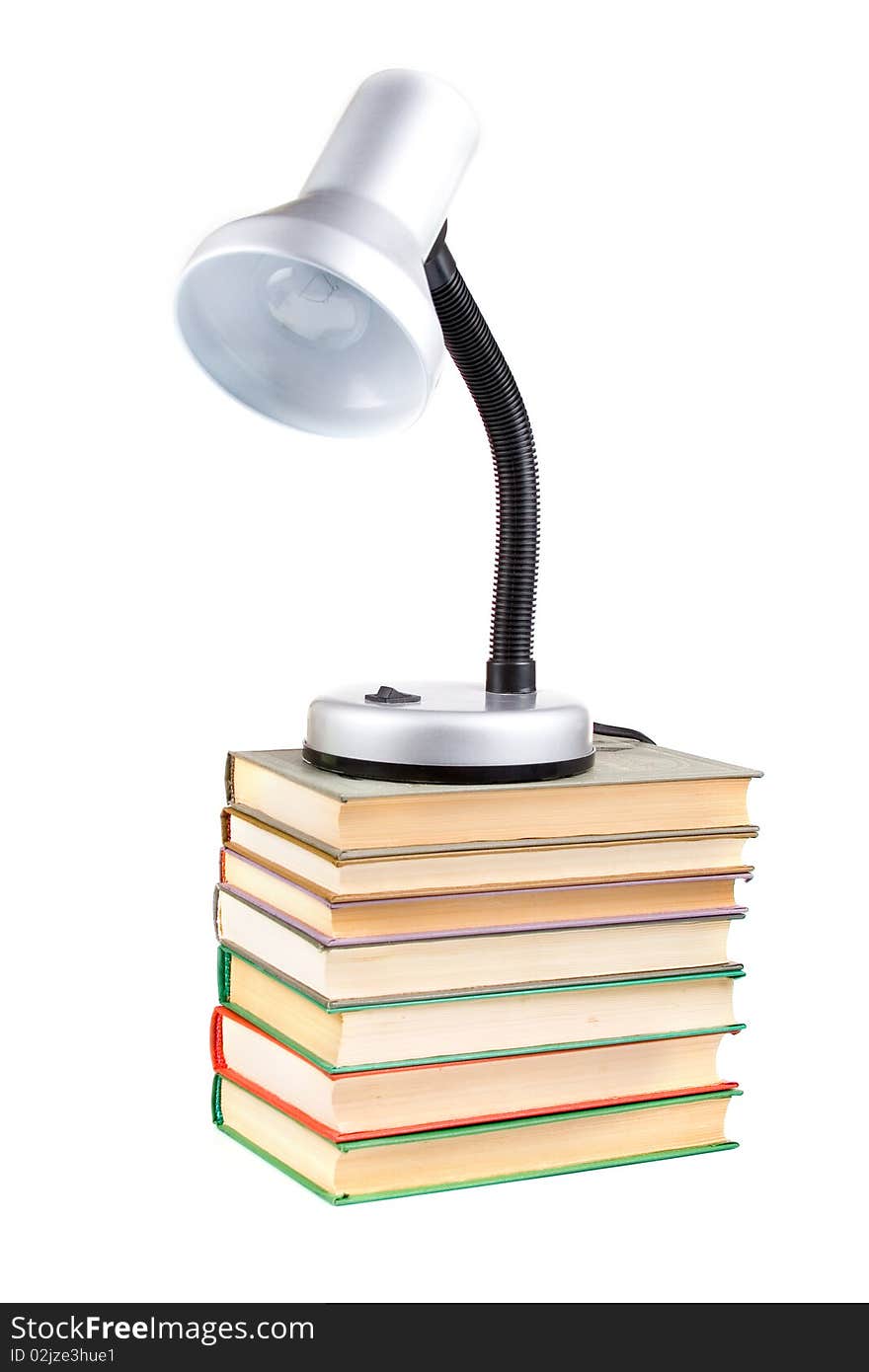 Table lamp on the books isolated on white background