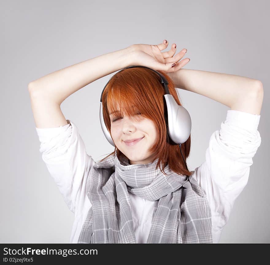 Girl with modern headphones. Studio shot.