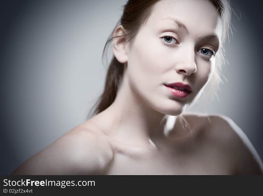 Beauty redhaired woman closeup portrait on gray background. Beauty redhaired woman closeup portrait on gray background