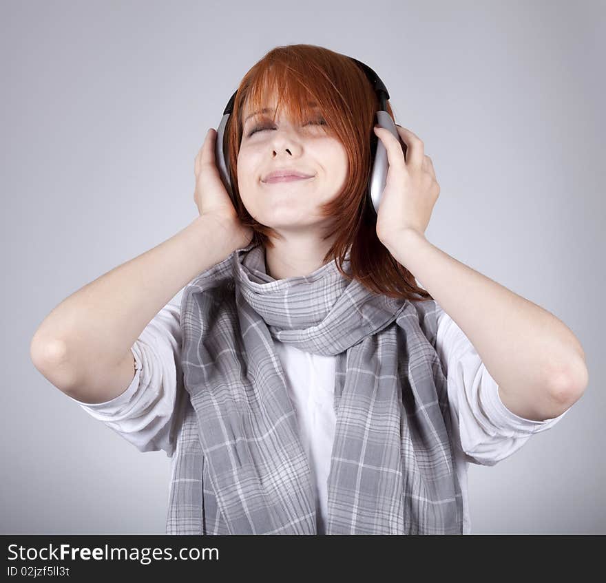 Girl with modern headphones. Studio shot.