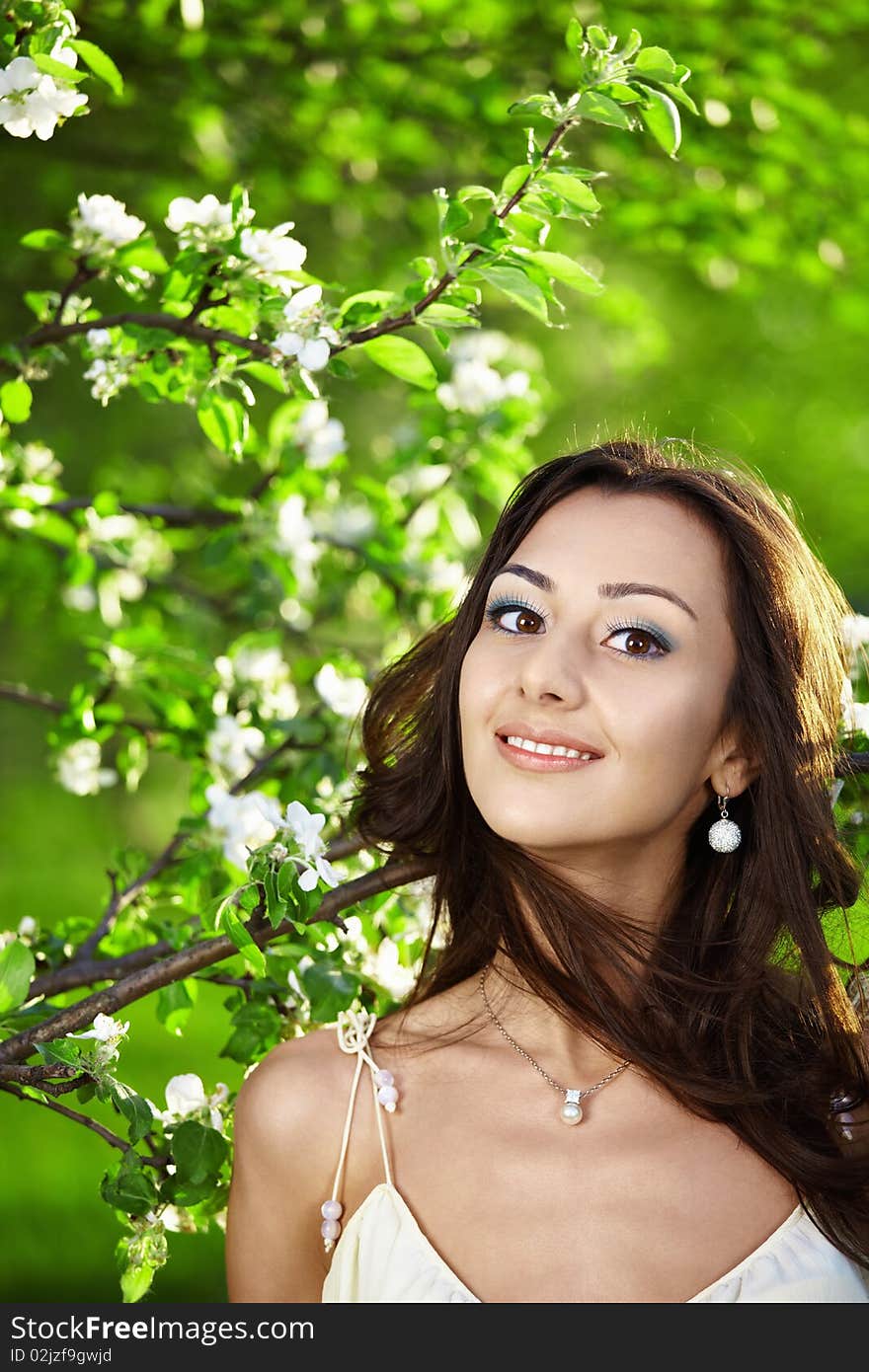 The attractive young girl in greens of trees. The attractive young girl in greens of trees