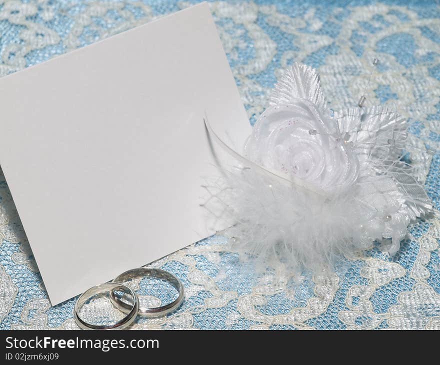 White card for congratulation on a background from blue  silk and white lace. White card for congratulation on a background from blue  silk and white lace