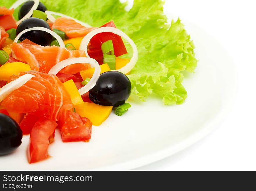 Vegetable salad with salmon isolated on white, the focus at the center of plates