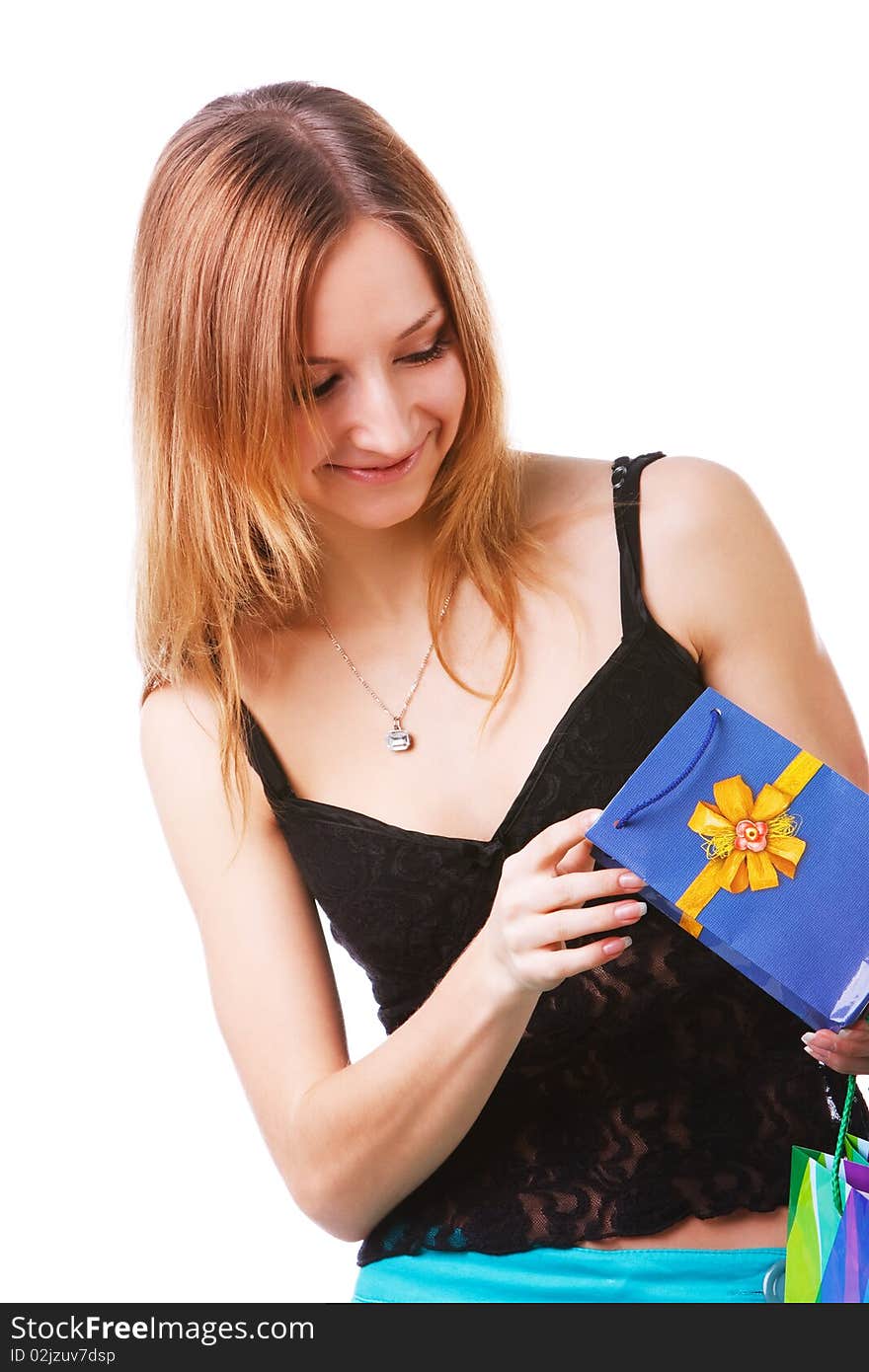 Picture of a beautiful young lady which looking into packets with a gift on white background. Picture of a beautiful young lady which looking into packets with a gift on white background.