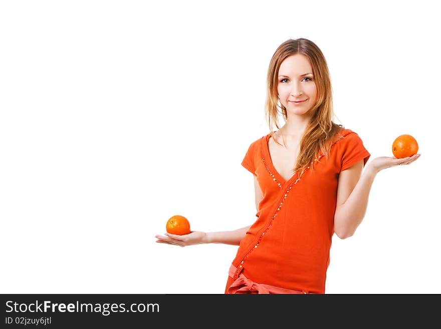 Young pretty girl in dress with oranges