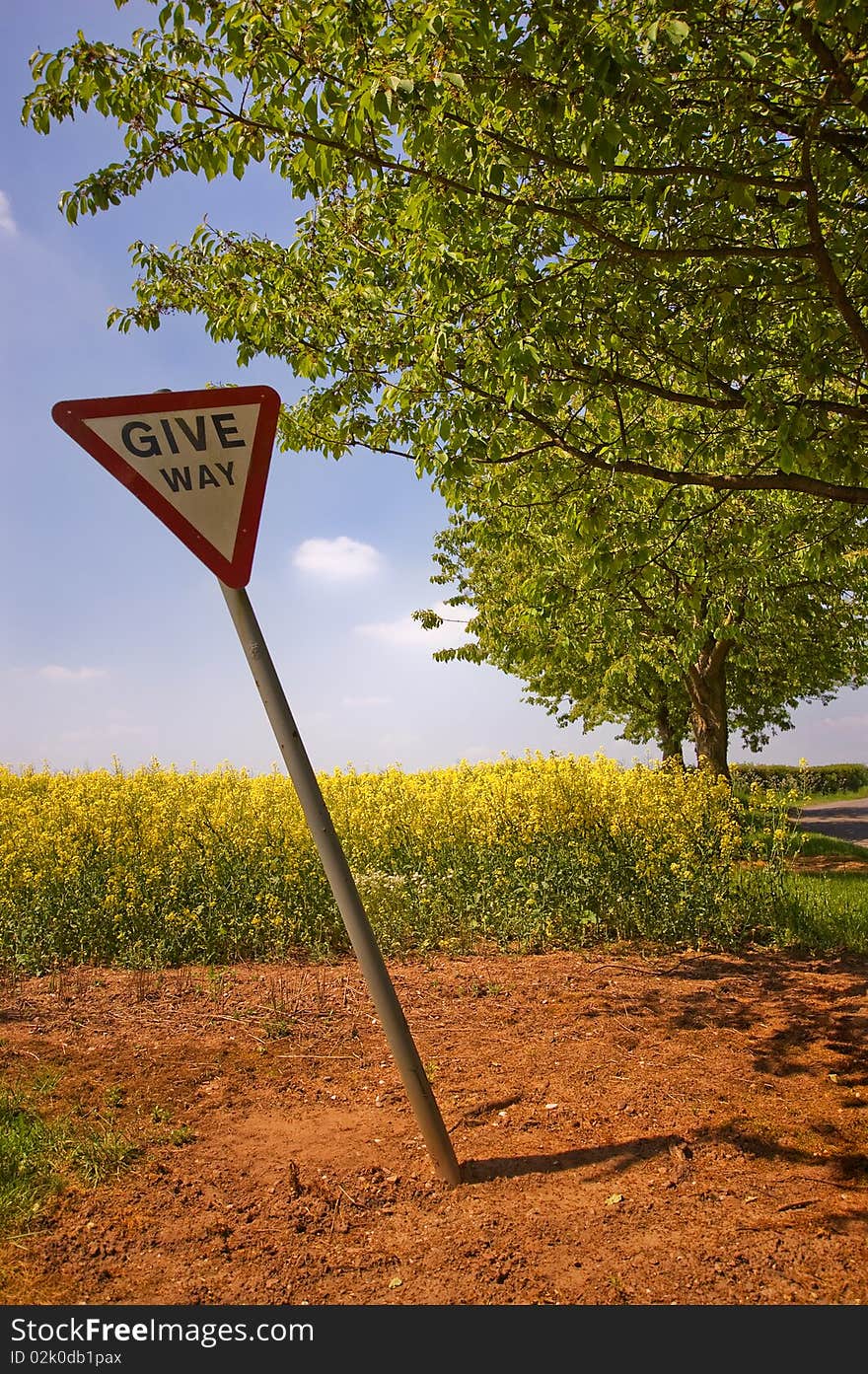 Crooked road sign by the field. Crooked road sign by the field