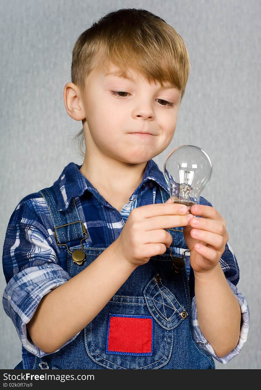 Little boy with electro light bulb. Little boy with electro light bulb