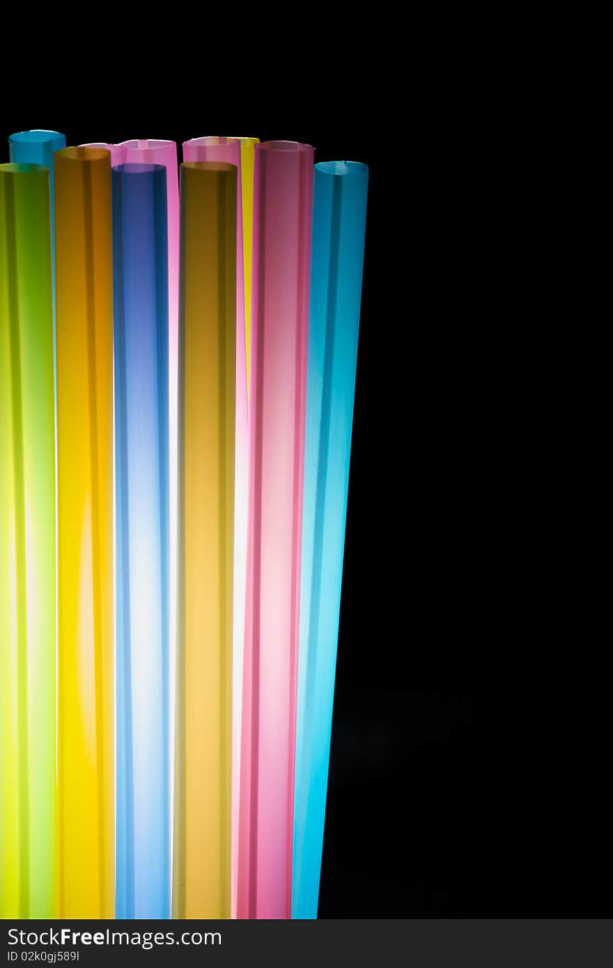 Colorful straw in the isolated black background. Colorful straw in the isolated black background.