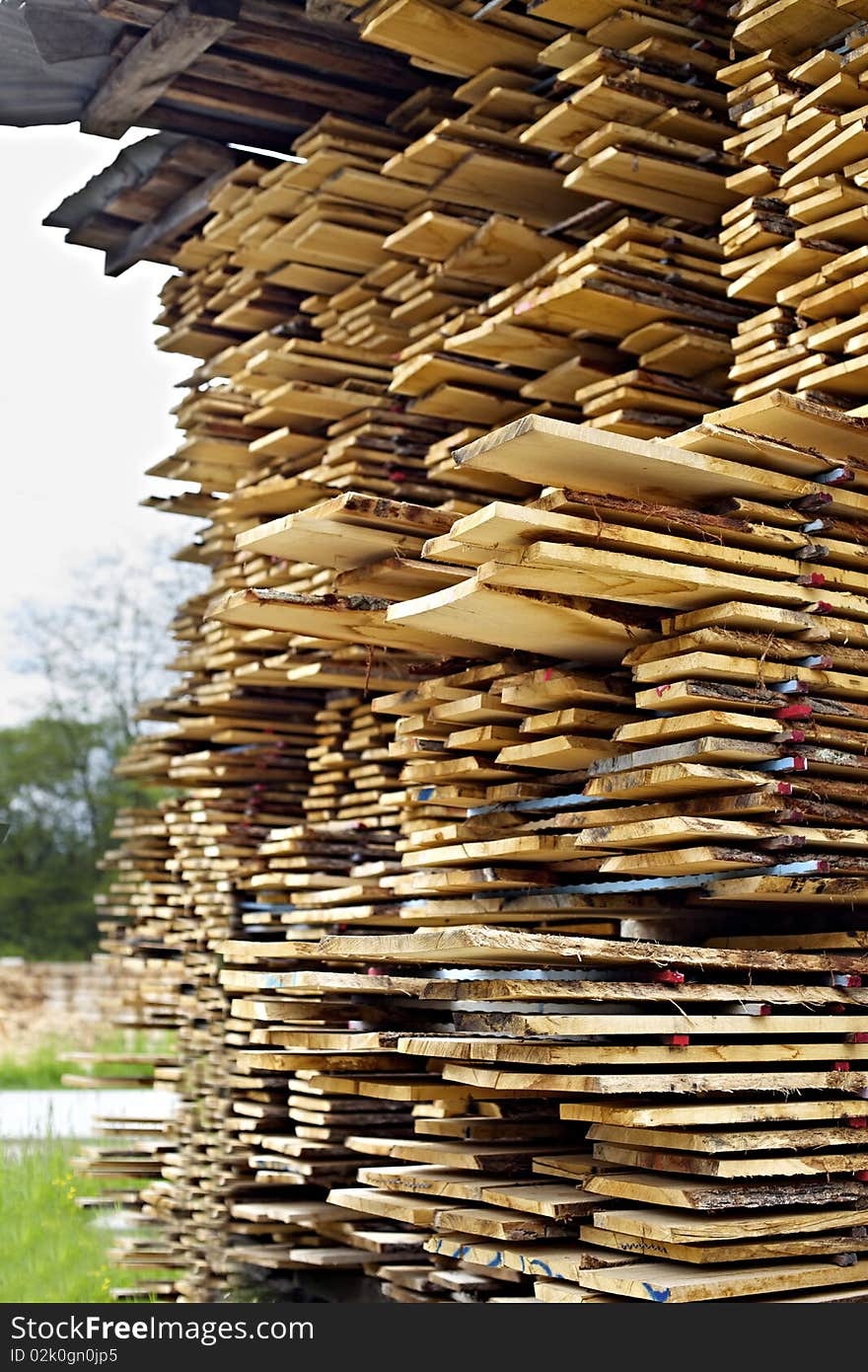 Stack of cut wood boards, side view.