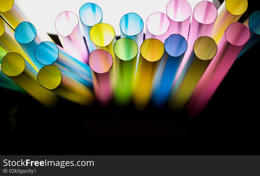 Colorful straw in the isolated black background. Colorful straw in the isolated black background.