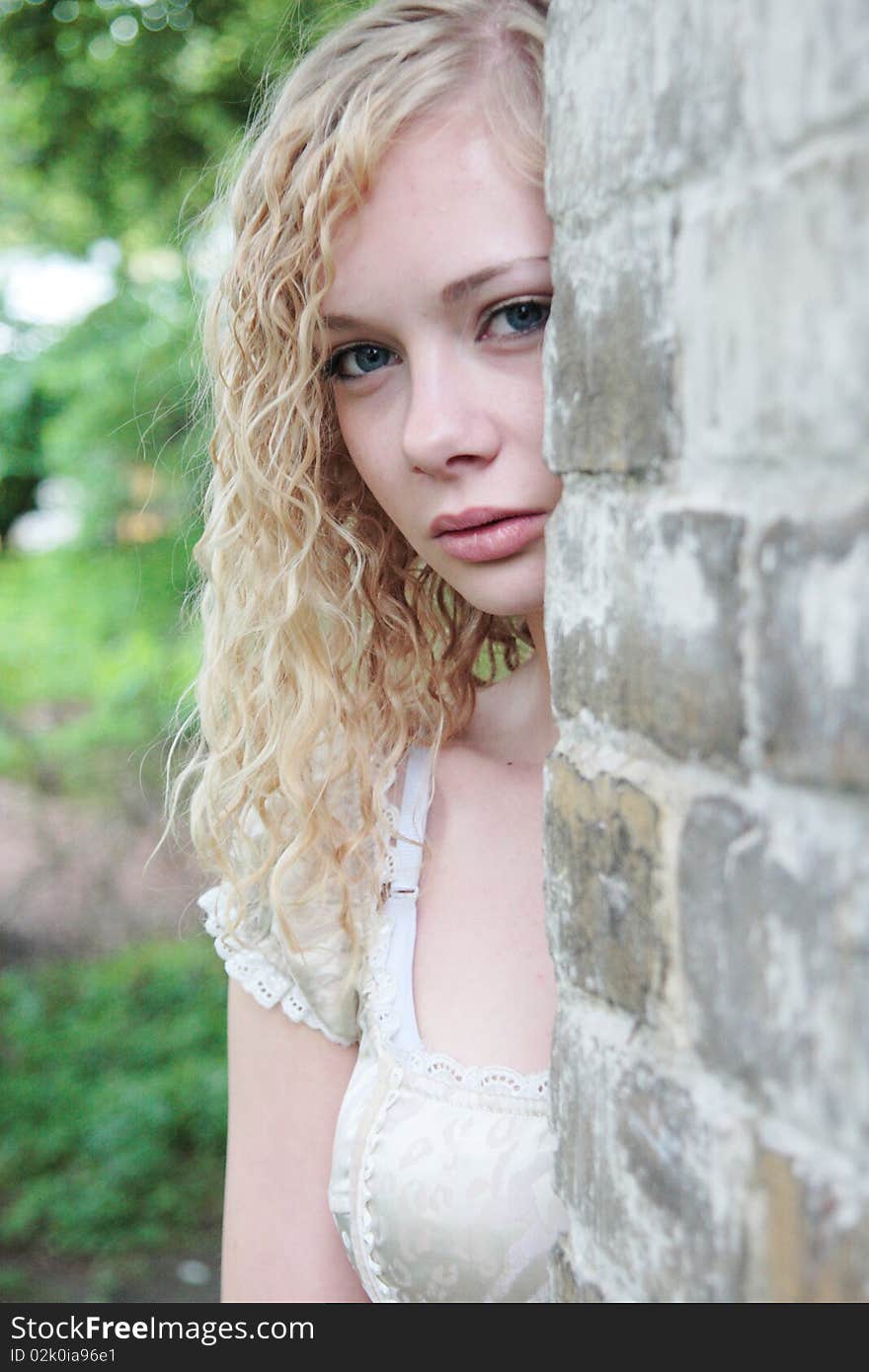 Girl looks out of the wall