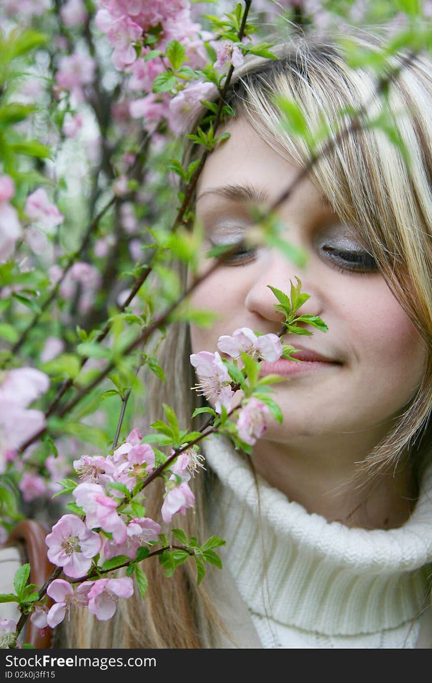 Girl smelling  flowers