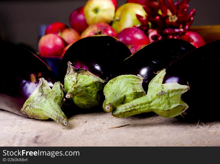 Aubergine on raw wood in the kitchen