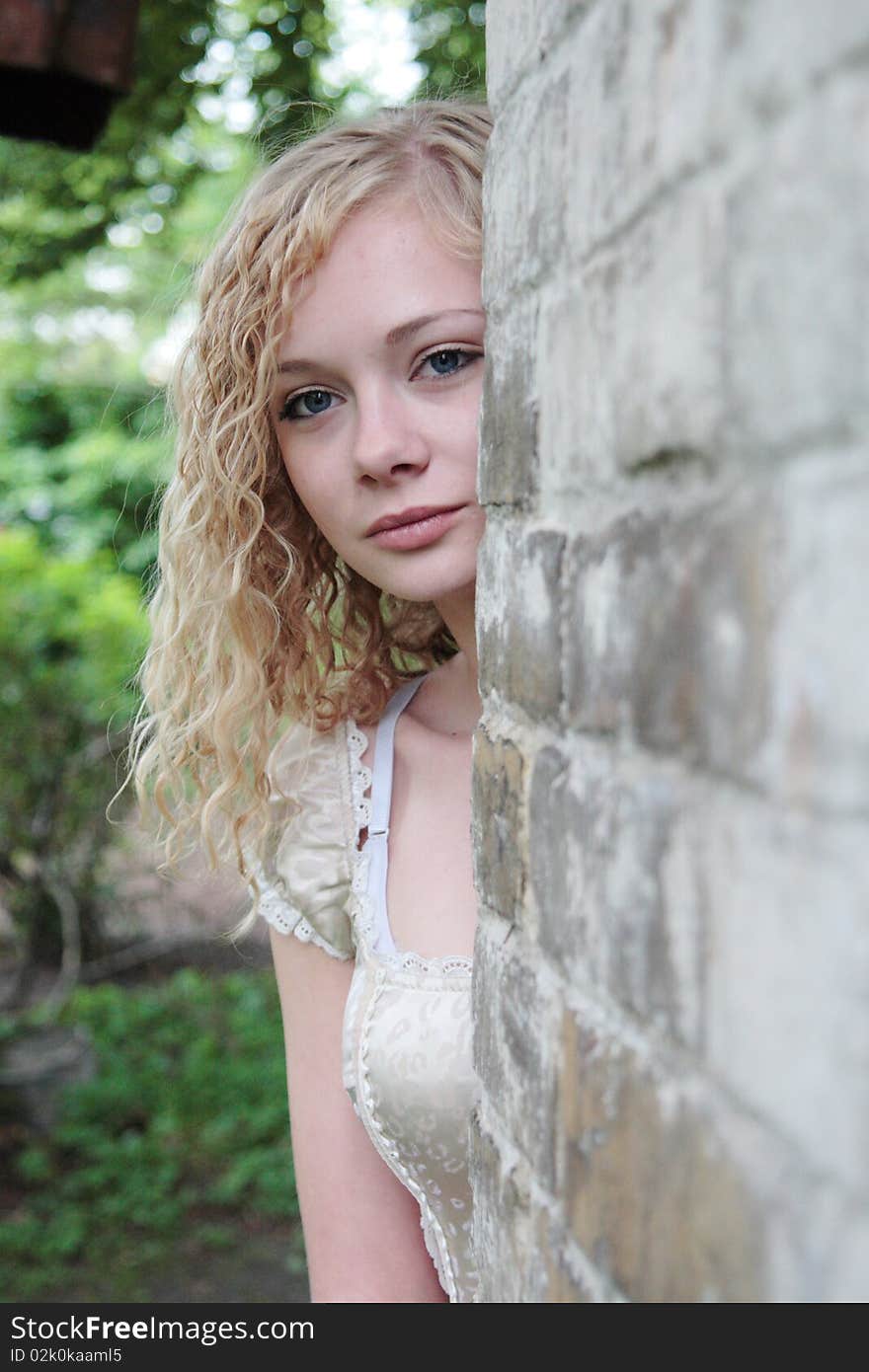 The girl looks frightened out of the wall