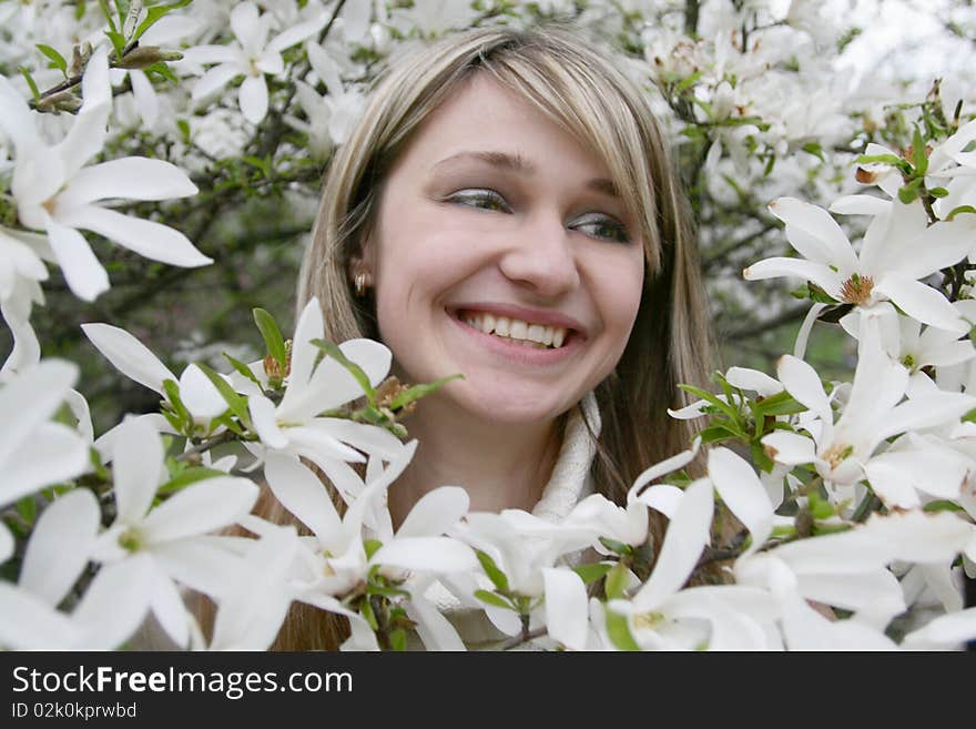 Young girl with a smile among the flowers. Young girl with a smile among the flowers