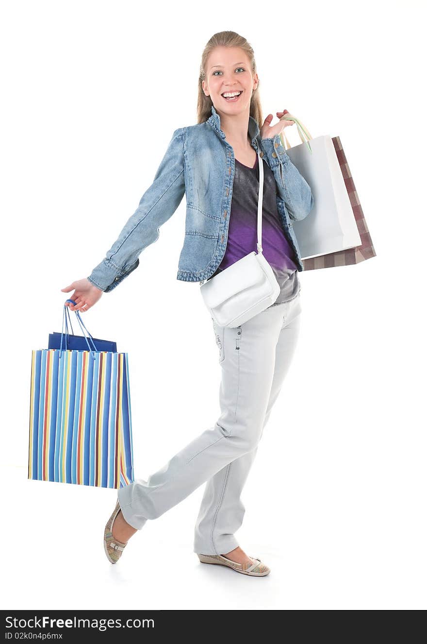 Young girl with purchases on white background