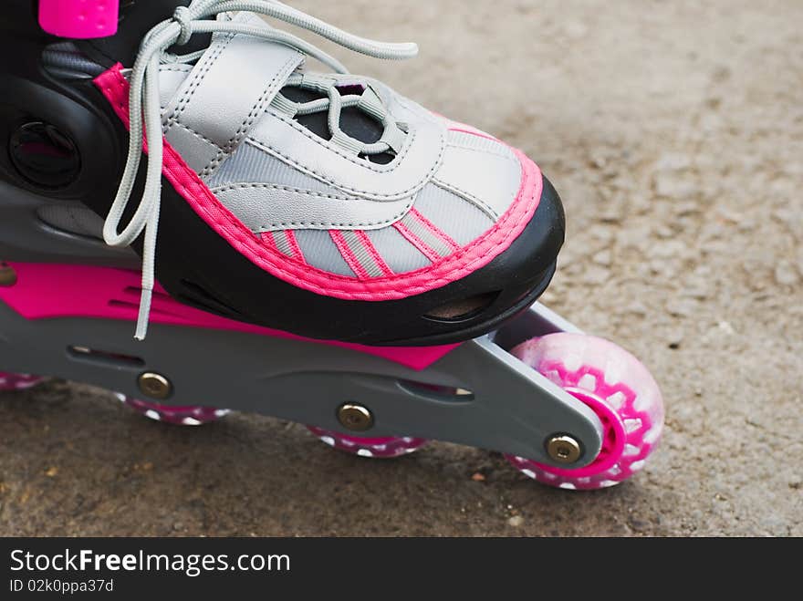 Roller skates on asphalt, close-up. Roller skates on asphalt, close-up