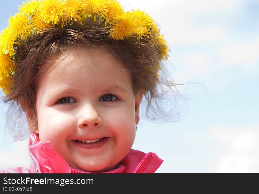 Girl and a wreath of dandelions