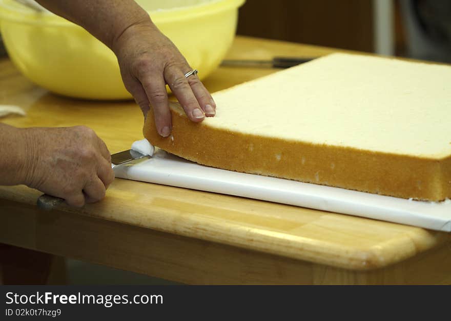 Icing is applied between the board and cake layer to firm it into place. Icing is applied between the board and cake layer to firm it into place