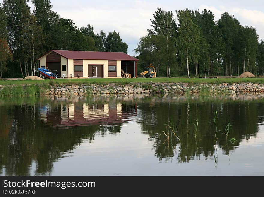 Shed with tractor and boat on a lake