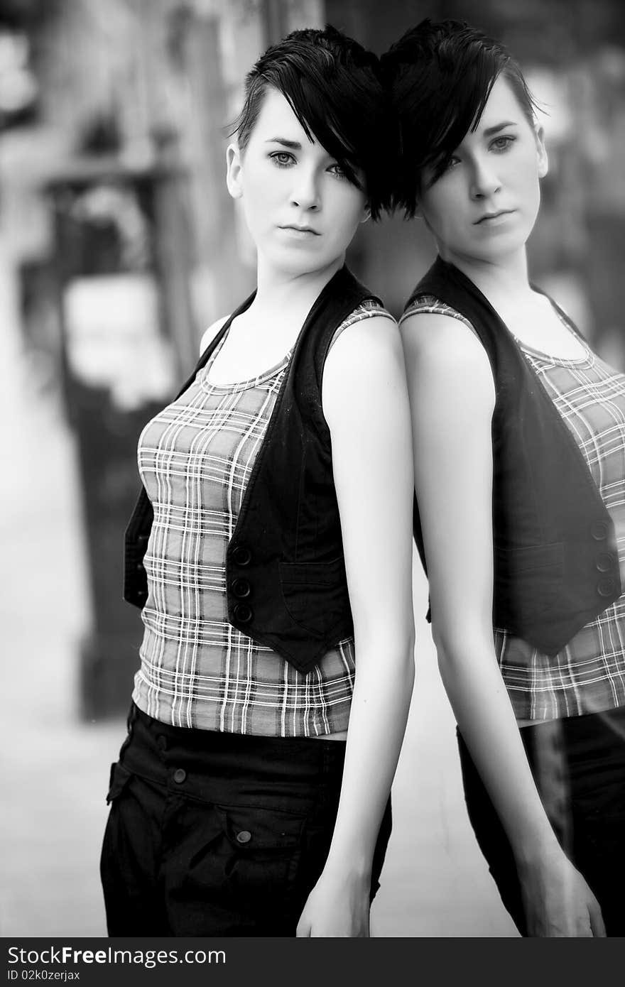 Young modern looking girl reflected on mirror. Young modern looking girl reflected on mirror