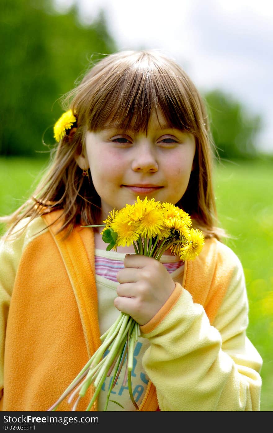 Little girl in the flowering field