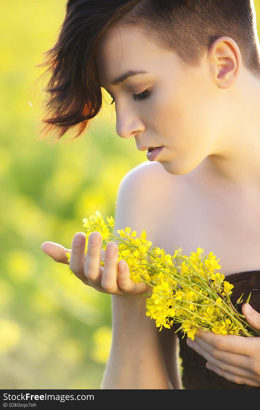 Young girl portrait holding yellow flowers. Young girl portrait holding yellow flowers