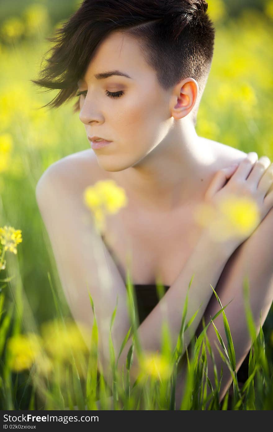 Sensual young girl surrounded by yellow flowers. Sensual young girl surrounded by yellow flowers