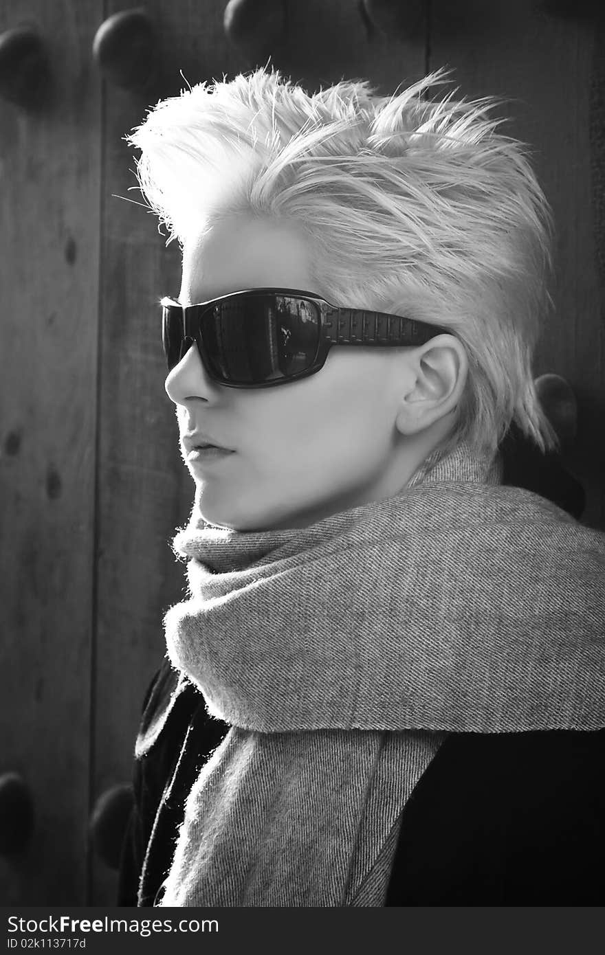 Young blond woman in winter fashion wearing sunglasses. Young blond woman in winter fashion wearing sunglasses.