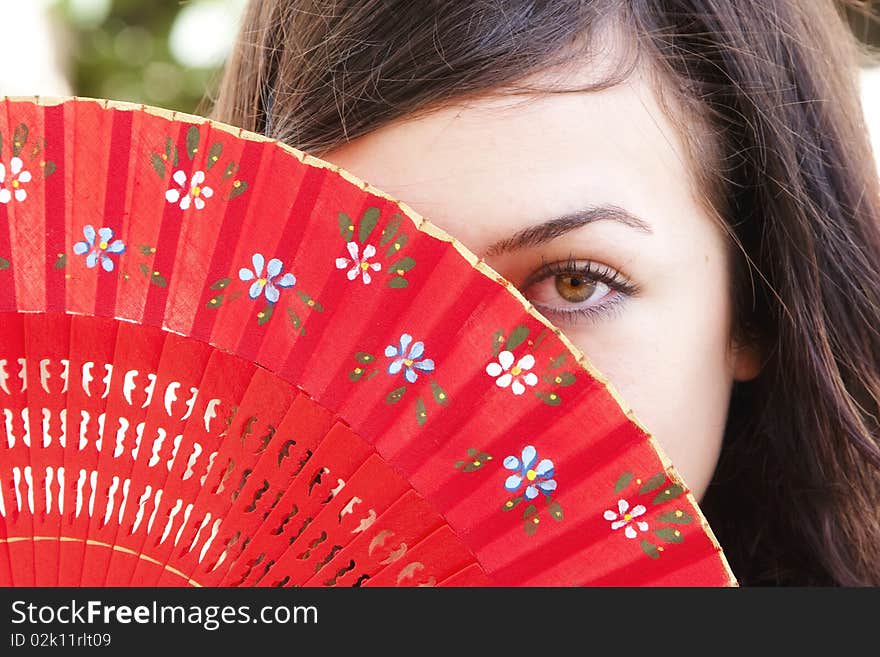 Spanish woman behind traditional fan. Spanish woman behind traditional fan.