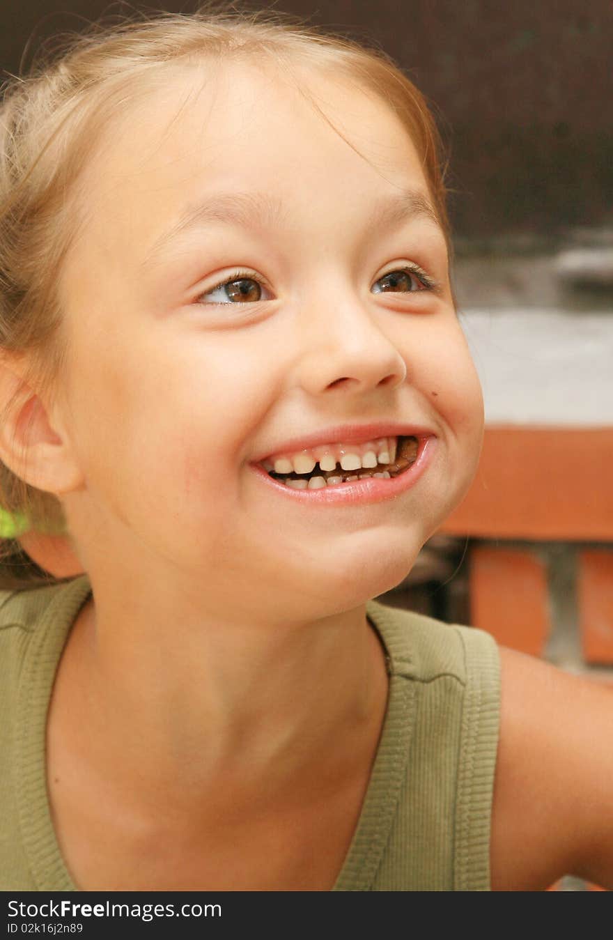 Girl chews food and smiles