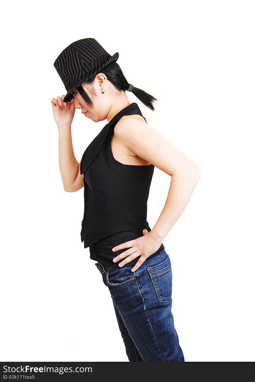 A young Asian woman with an back hat and west und jeans with short black hair, leaning forward and holding her hat, for white background. A young Asian woman with an back hat and west und jeans with short black hair, leaning forward and holding her hat, for white background.