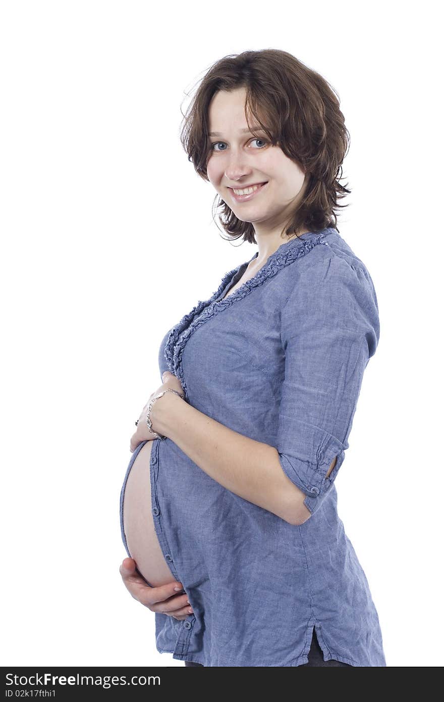 Beautiful pregnant young woman smiling, in a shirt. Beautiful pregnant young woman smiling, in a shirt