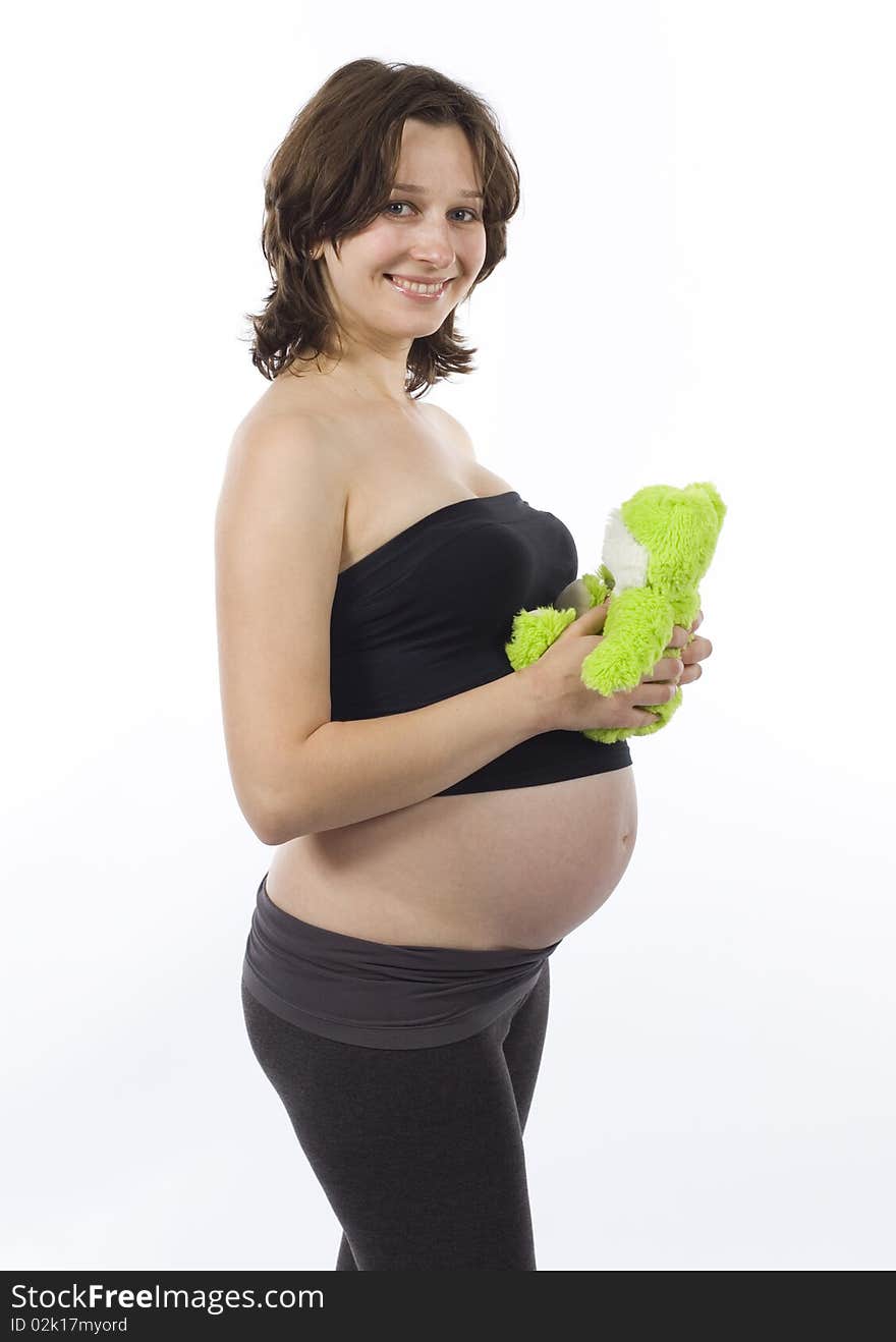 Beautiful pregnant woman with fur toy smiling. Beautiful pregnant woman with fur toy smiling