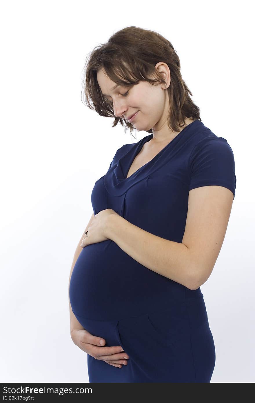 Beautiful pregnant young woman in a blue dress. Beautiful pregnant young woman in a blue dress