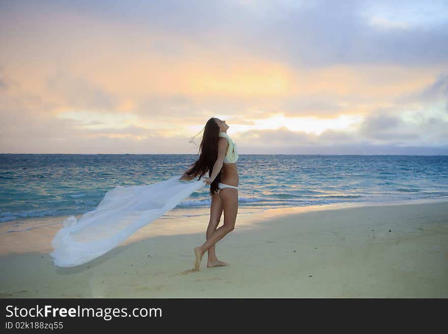 Woman on lanikai beach at sunrise