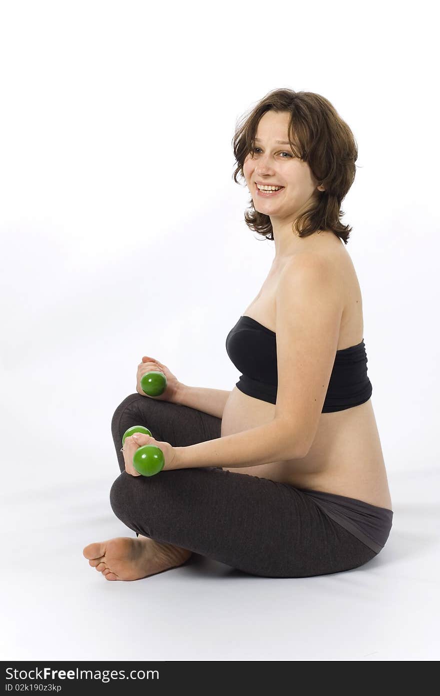 Beautiful pregnant woman doing sport with weights. Beautiful pregnant woman doing sport with weights