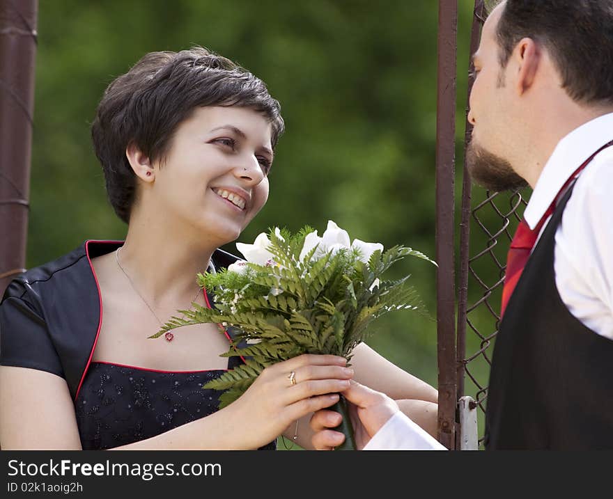 Man offering flowers to young beautiful woman. Man offering flowers to young beautiful woman