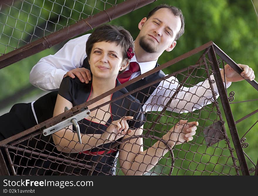 Happy young couple posing - looking from behind door