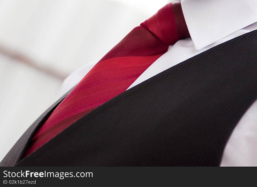 White shirt, black suit and red tie