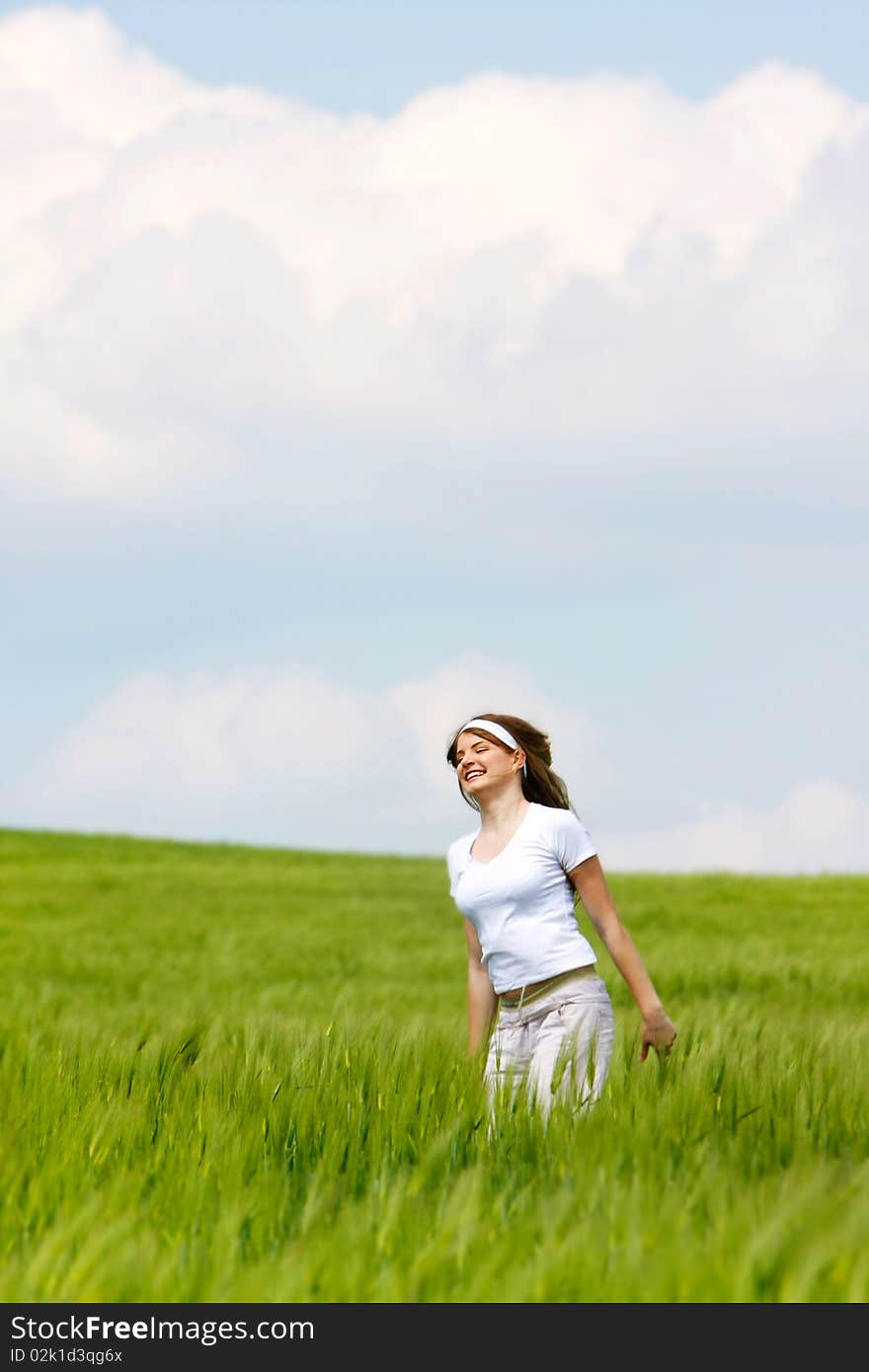 Young happy girl in green grass