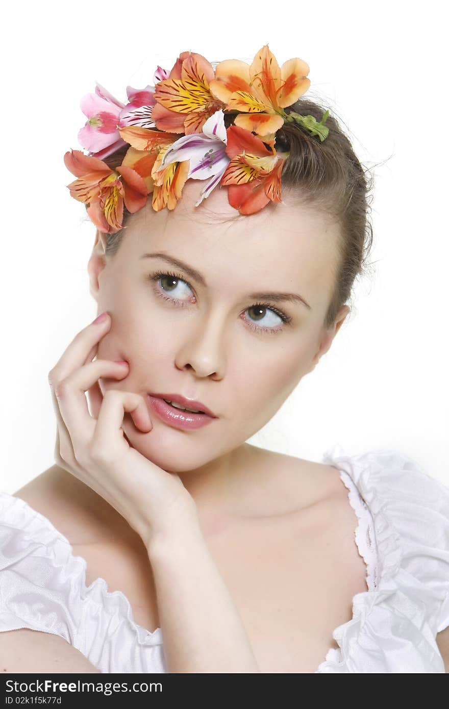 Young beautful woman in floral wreath over white